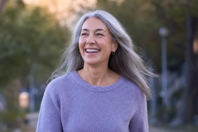 A woman walking outdoors on a bright morning